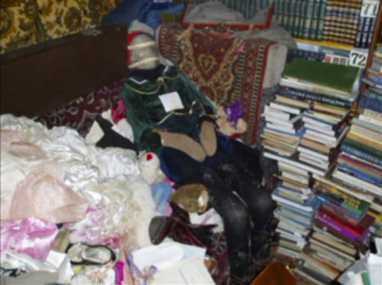 This photo provided by the Russian Interior Ministry's branch in the Nizhny Novgorod region shows a mummified body at an apartment dressed up like a doll taken from a grave at an apartment in Nizhny Novgorod, some 400 kilometers (250 miles) east of Moscow. 